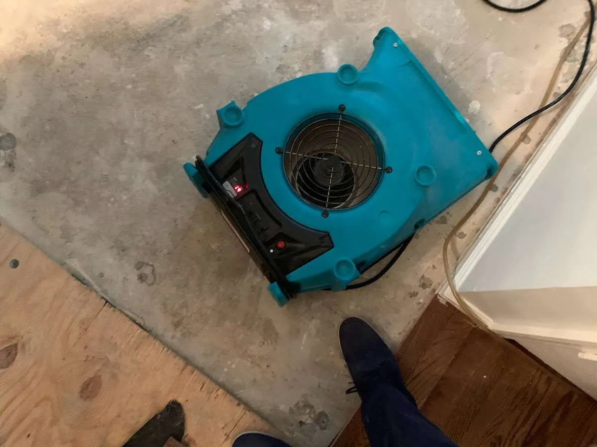 Air mover drying subfloor during Commercial Water Damage Restoration in Harrah